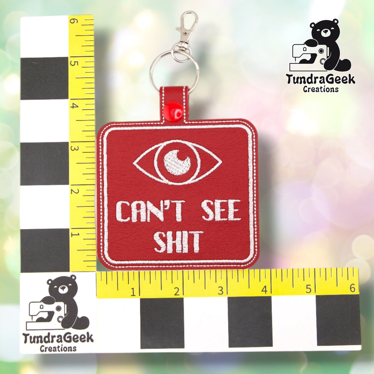 Red Can't See Shit badge shown against a black-and-white checkered background with a yellow ruler for scale, measuring 3.75 inches wide by 5.25 inches tall including hardware.