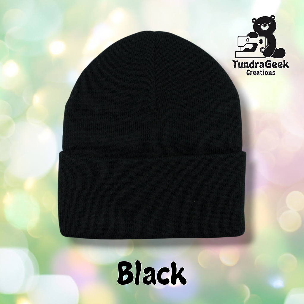 Plain black cuffed beanie on a pastel bokeh background. Text reads "Black" at the bottom of the image.