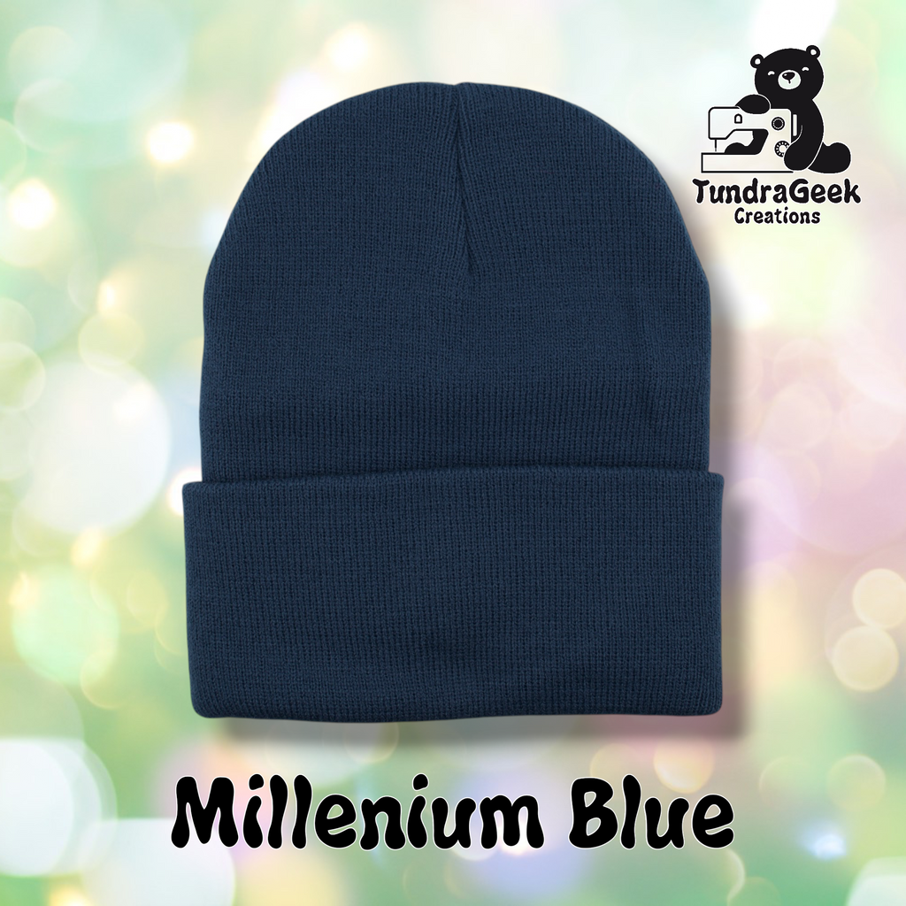 Plain dark navy/Millennium Blue cuffed beanie on a pastel bokeh background. Text reads "Millenium Blue" at the bottom of the image.