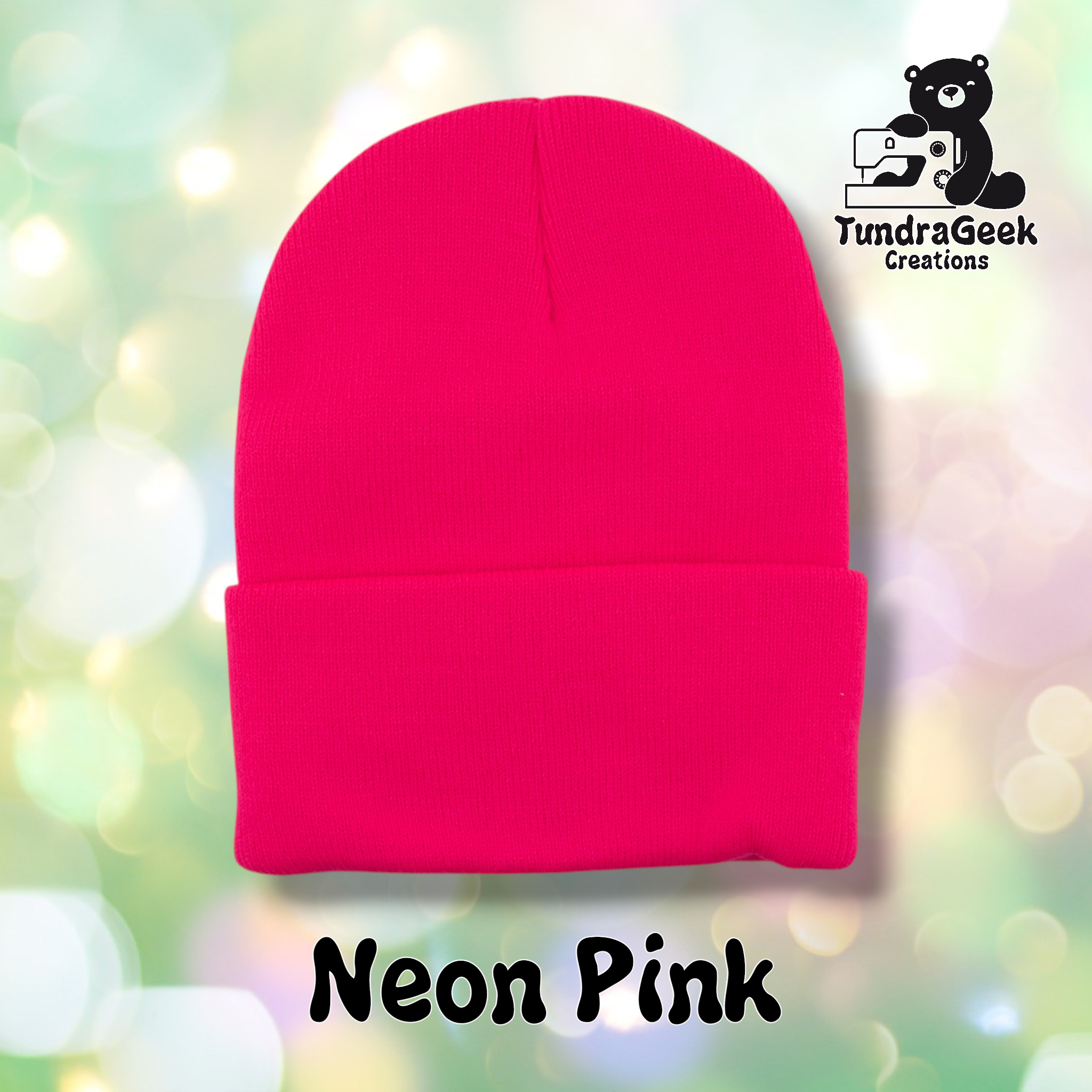 Plain neon pink cuffed beanie on a pastel bokeh background. Text reads "Neon Pink" at the bottom of the image.