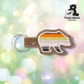Front of a bear-shaped vinyl keychain embroidered with the Bear Pride flag stripes (brown, orange, yellow, white, gray, black) from top to bottom. Brown vinyl edge with white outline stitching. Olive snap closure and metal split ring at top.