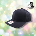 A black baseball cap with a white rectangular brand label on the front bill, displayed against a soft bokeh background.
