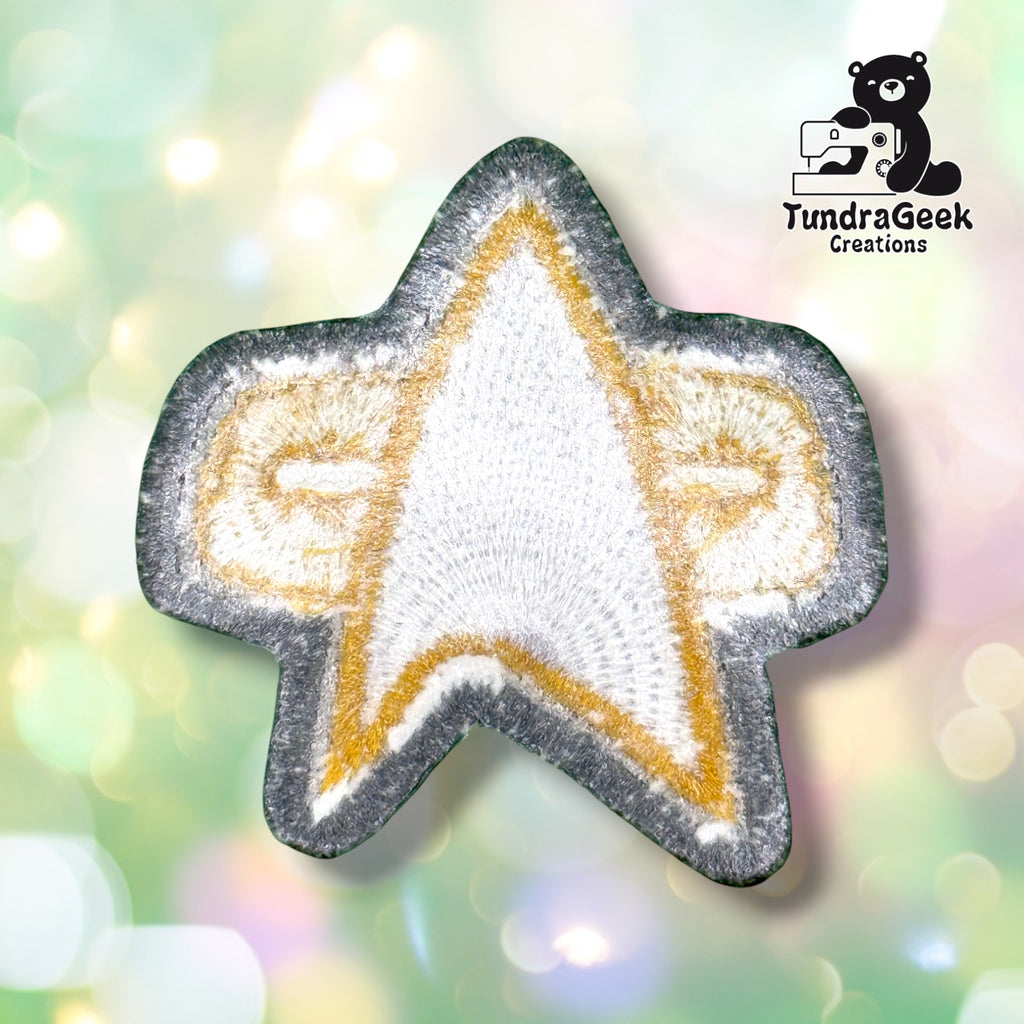 The backing of the star-shaped patch, showing embroidery texture from the reverse side.