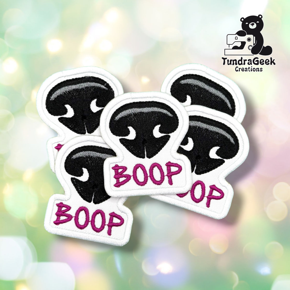 Four Dog Nose Boop patches fanned out together, each showing the same black nose design with magenta "BOOP" lettering.