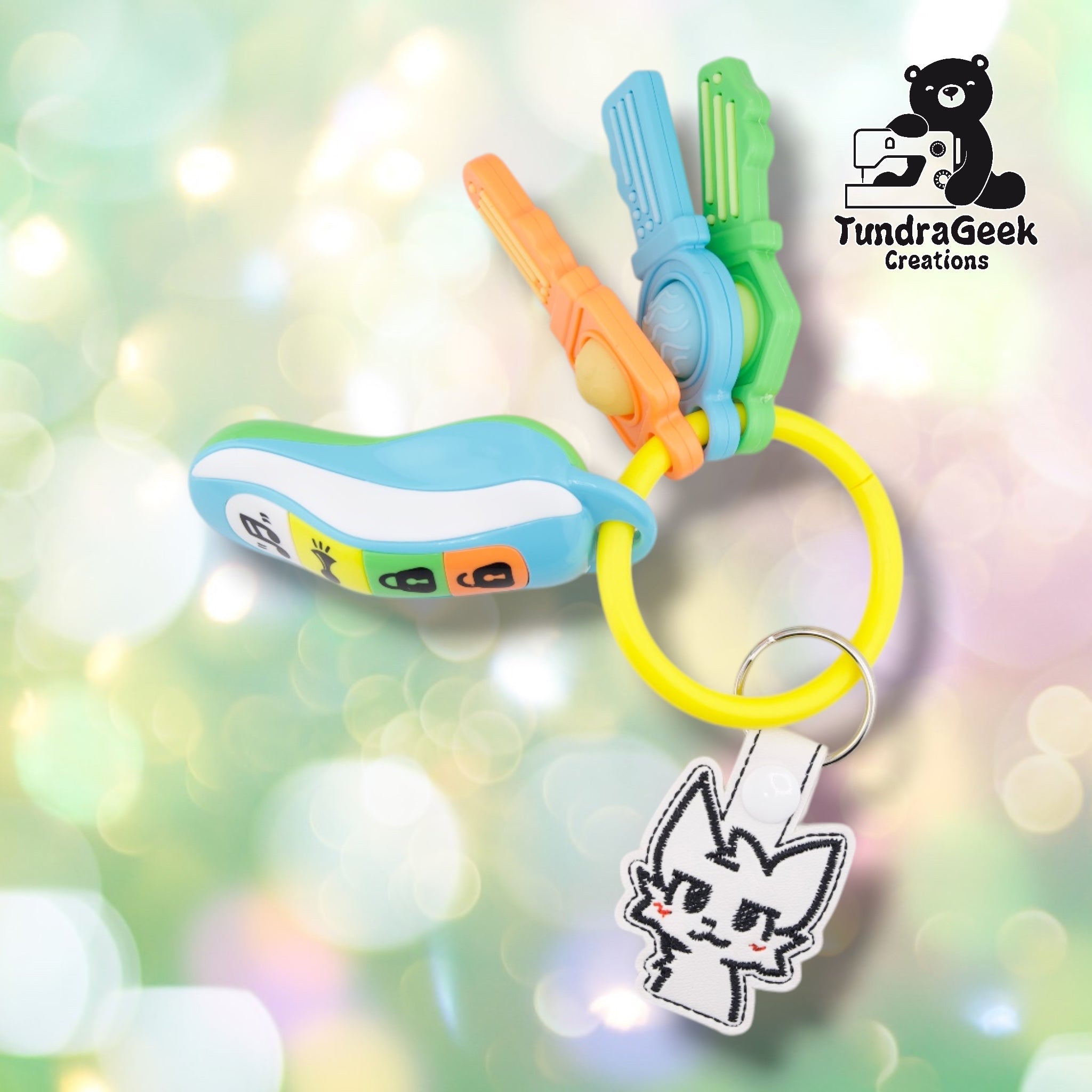 A Boykisser keychain attached to a keyring alongside several colorful clip-on fidget toys, shown as a lifestyle/context photo.