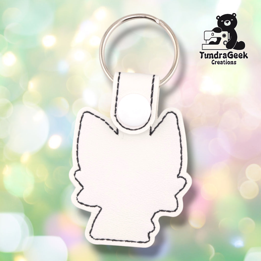 Back of the keychain showing the plain white faux leather backing with the cat-shape silhouette stitched in black outline only — no facial embroidery visible from this side.