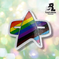 Close-up of a single delta badge sticker with rainbow stripes transitioning into brown, black, light blue, and pink, finished with a clean white border on removable glossy vinyl.