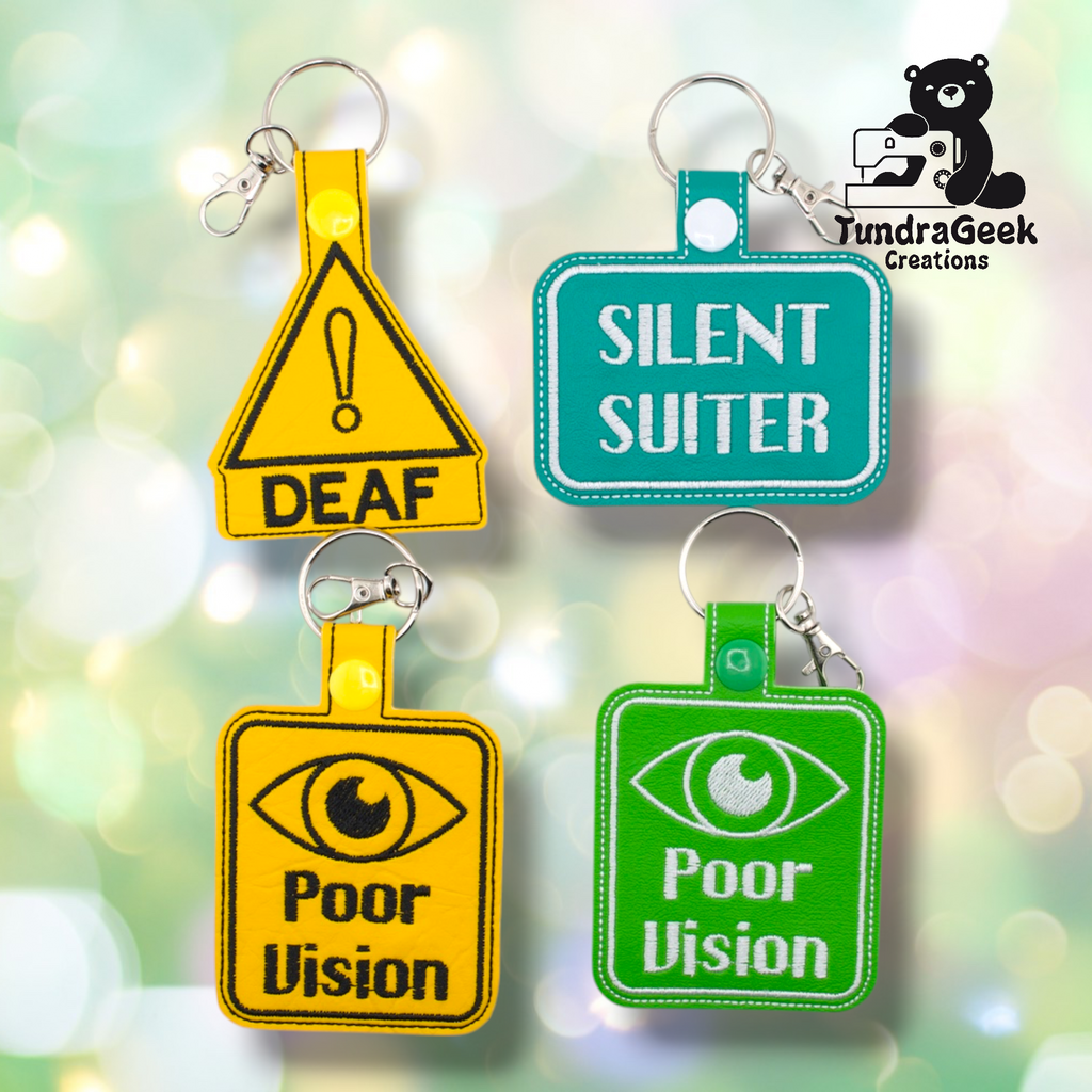 Four embroidered keychains are shown, labeled DEAF, SILENT SUITER, and Poor Vision in yellow and green, with a sewing-themed logo in the top right corner.