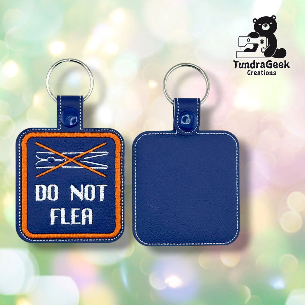 The front and back of the Do Not Flea badge side by side. On the left, the front: purple vinyl with an orange border, an orange X over a white line-art clothespin, and “DO NOT FLEA” in white. On the right, the back: plain purple vinyl with white topstitching. Each has a blue plastic snap and a silver split ring.