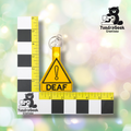 Yellow triangular keychain with a black exclamation mark and the word DEAF, placed on a measurement grid for scale, with the TundraGeek Creations logo in the corners.