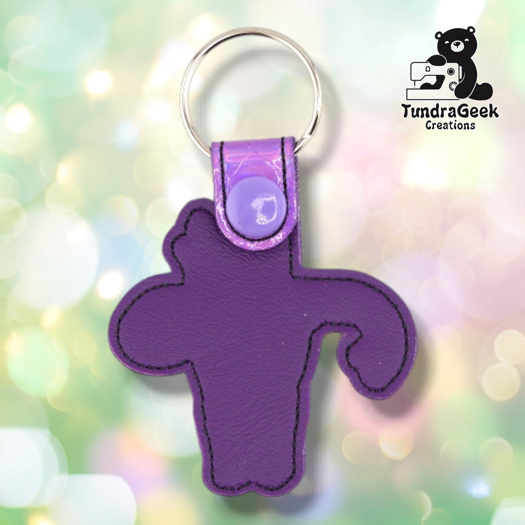 The back of the Metallic Lavender colorway, plain purple vinyl with black topstitching outlining the shape, and the iridescent tab with its lavender snap at the top.