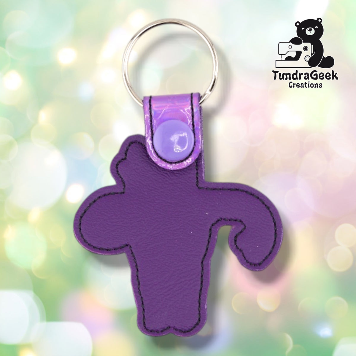 The back of the Metallic Lavender colorway, plain purple vinyl with black topstitching outlining the shape, and the iridescent tab with its lavender snap at the top.