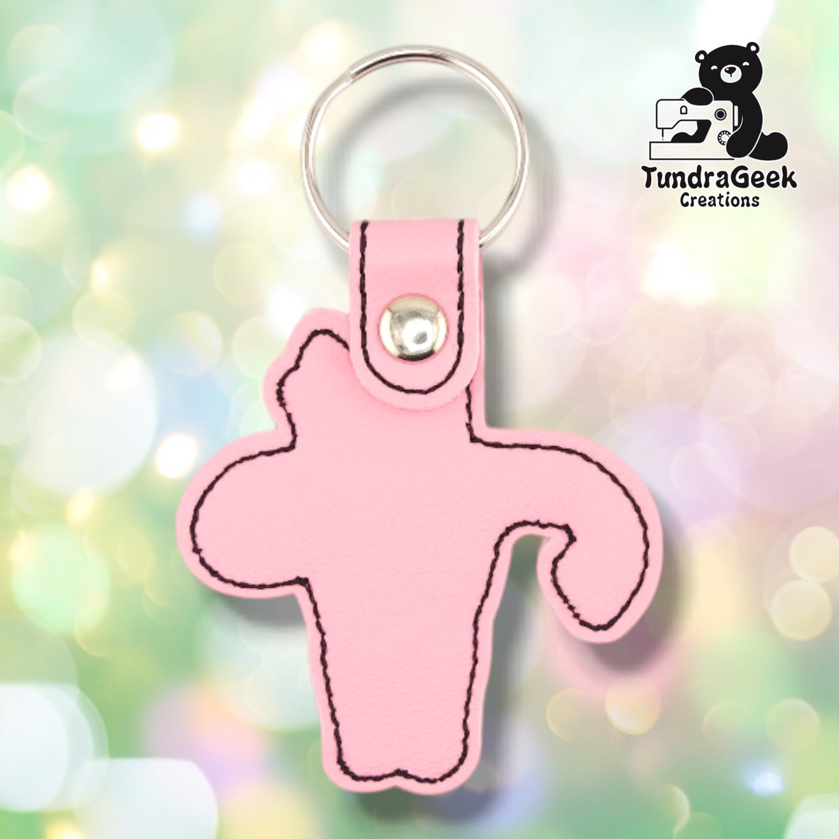 The back of the Pink colorway, plain pink vinyl with black topstitching following the outline of the shape, and the silver metal rivet at the top of the tab.
