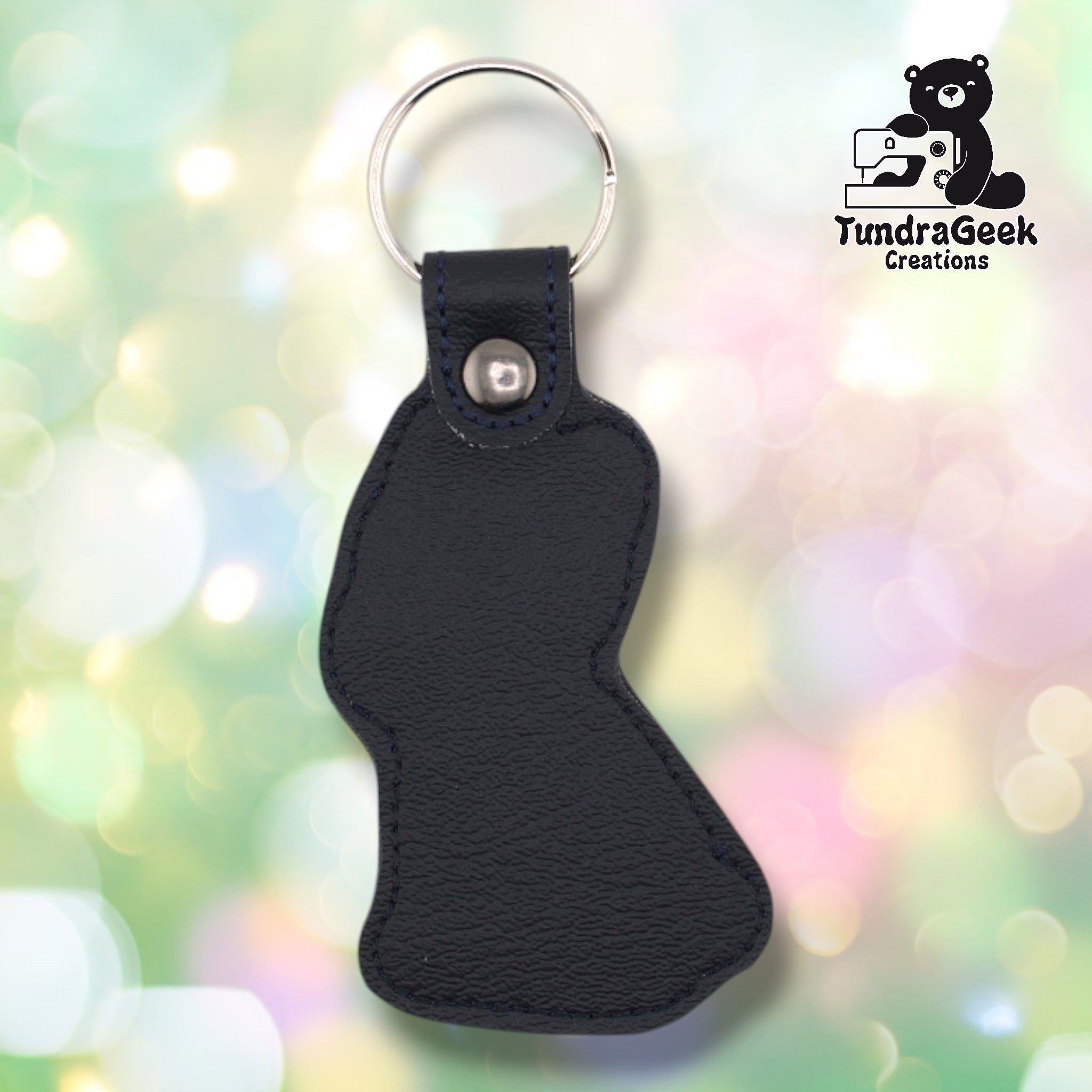 Back of a black faux leather French Bulldog keychain. The plain black vinyl back panel shows dark outline stitching following the seated Frenchie silhouette shape. A gunmetal 9mm metal rivet closure secures the tab, with a silver split ring attached above.