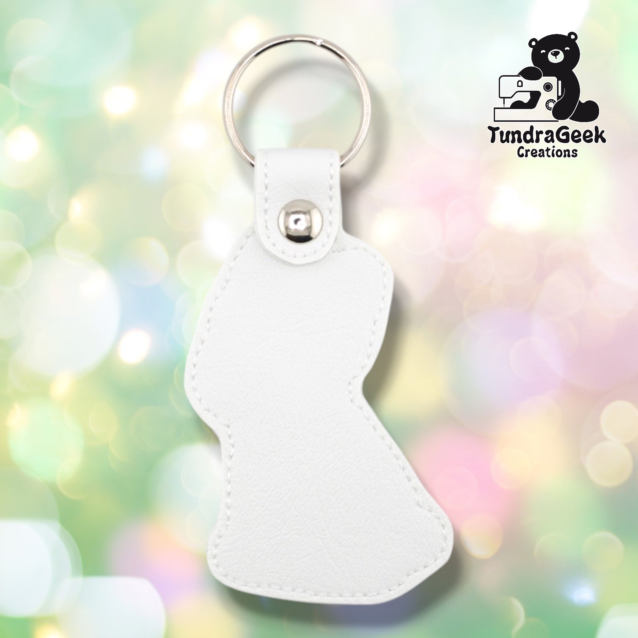 Back of a white faux leather French Bulldog keychain. The plain white vinyl back panel shows light outline stitching following the seated Frenchie silhouette shape. A silver 9mm metal rivet closure secures the tab, with a silver split ring attached above.
