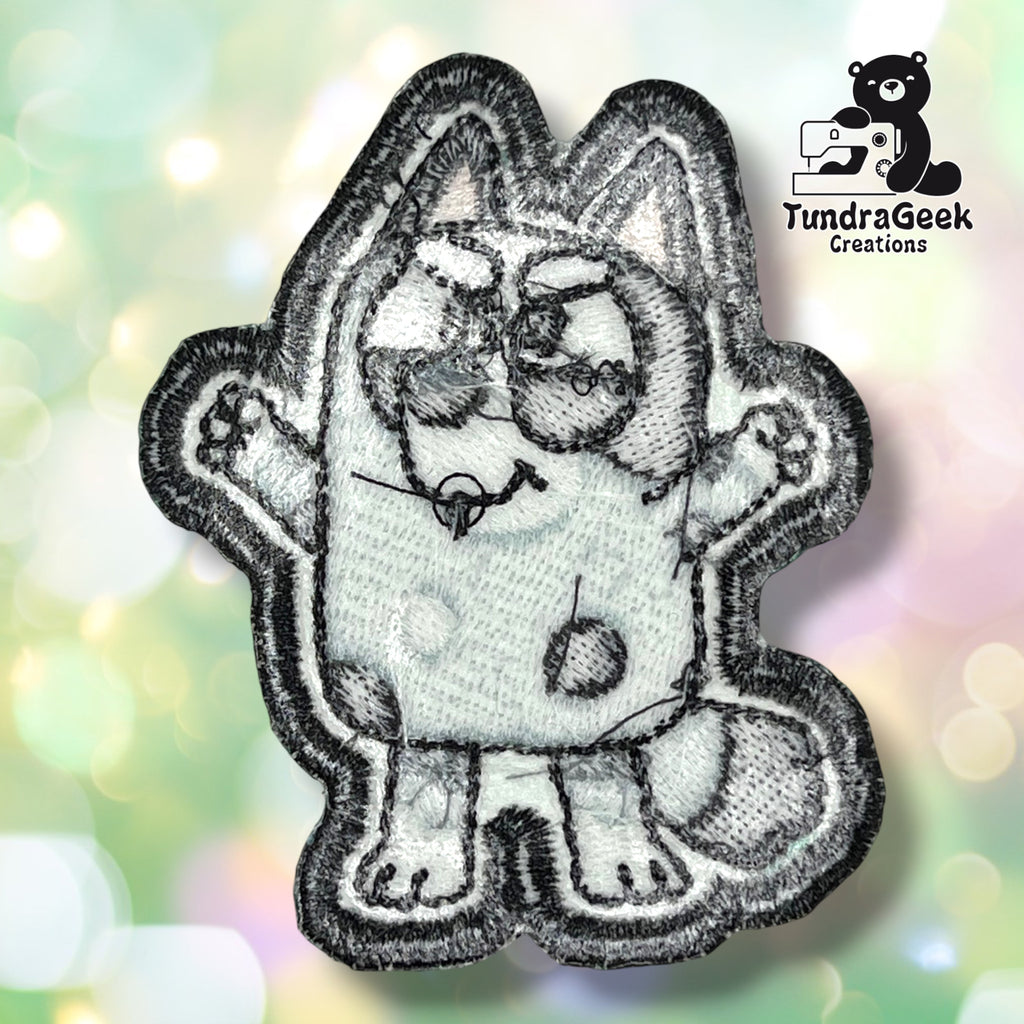 Back side of the heeler patch showing off the iron-on adhesive backing