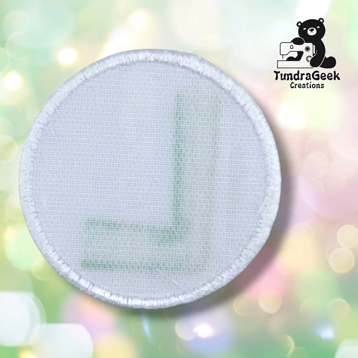 Back side of the Luigi L patch, showing off the hook and loop backing on the velcro-backed patch option.