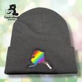 A dark gray knit beanie featuring an embroidered Alaska state outline filled with rainbow pride stripes; TundraGeek Creations logo in the top left corner.