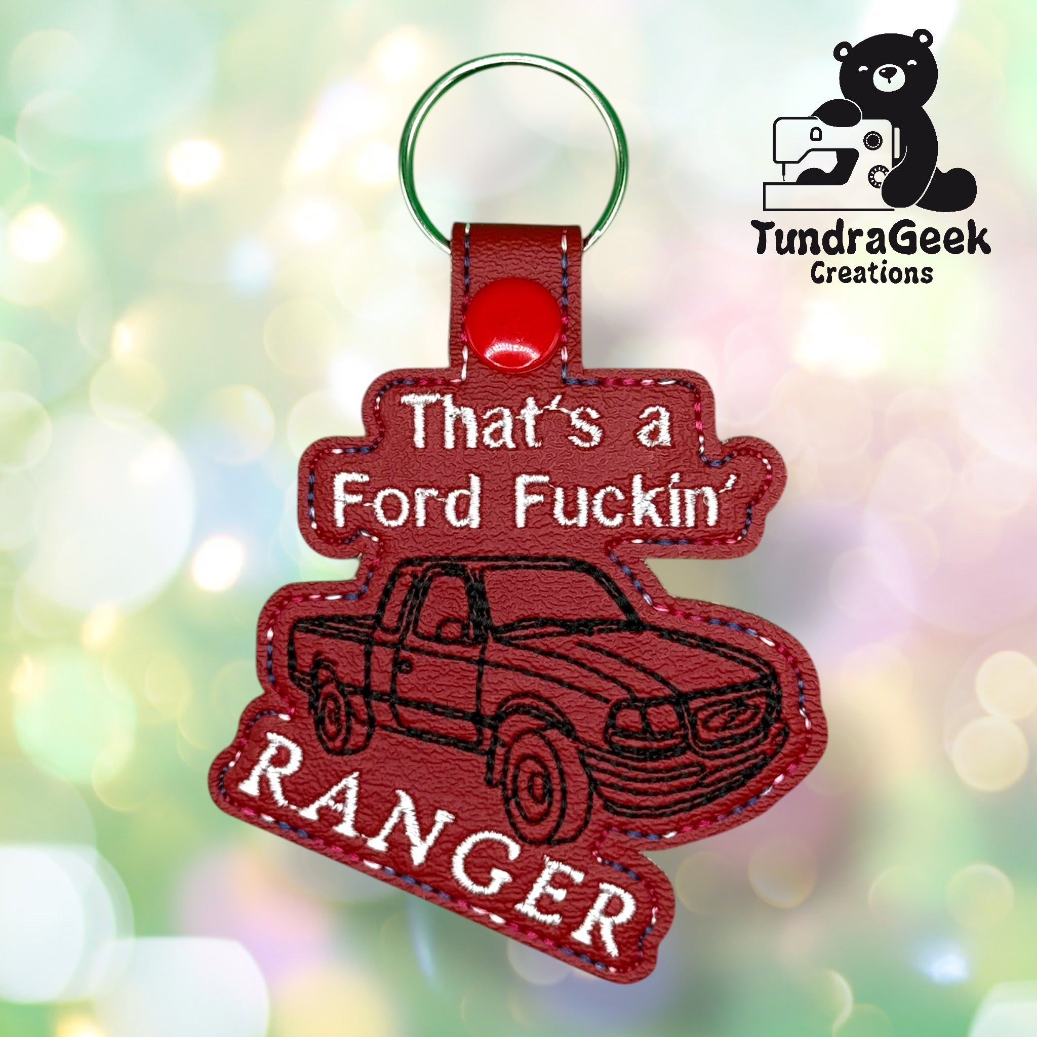 A red keychain shaped like a Ford Ranger truck with the text Thats a Ford Fuckin Ranger embroidered on it. TundraGeek Creations logo is in the top right corner.