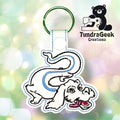 Embroidered keychain featuring a white, cartoon-style dragon with blue accents on a green key ring, shown with the TundraGeek Creations logo in the background.