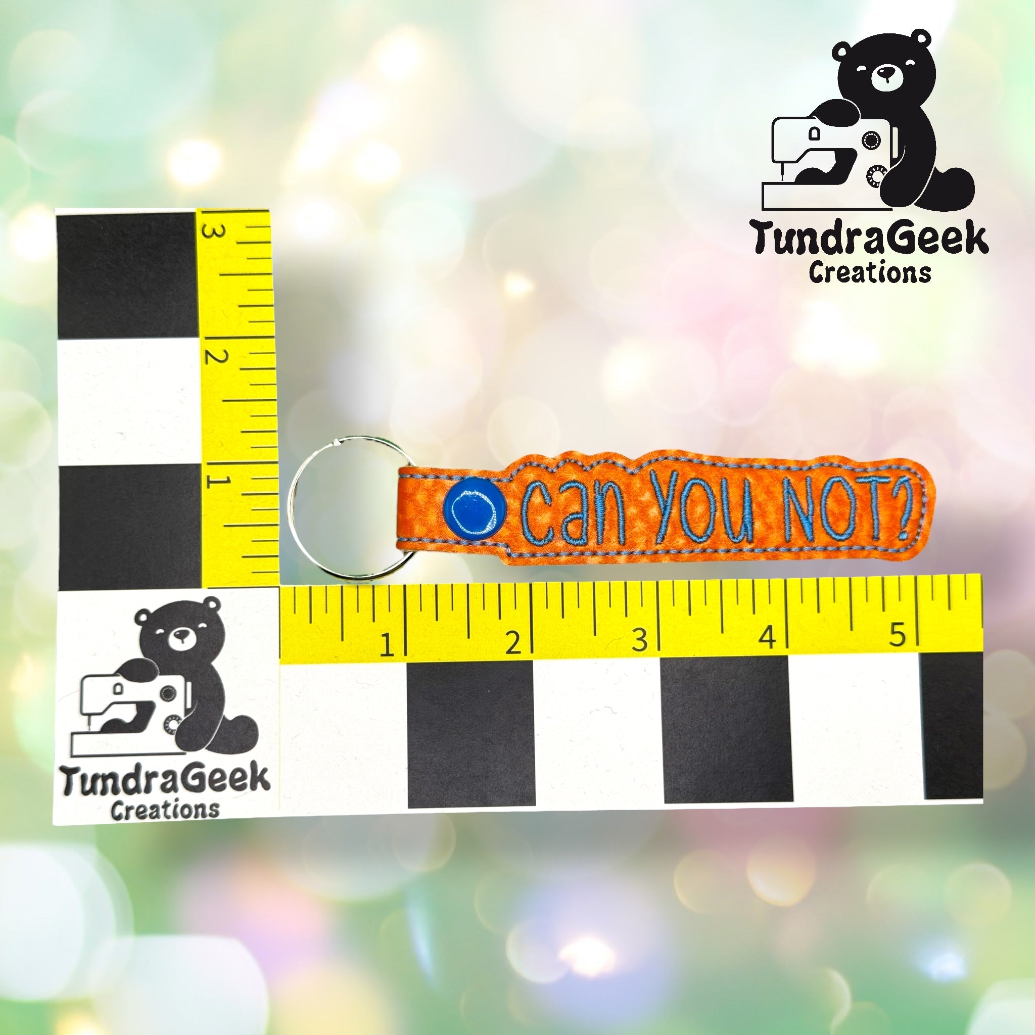 An embroidered keychain reading can you not? is shown next to a measurement grid with TundraGeek Creations logos, indicating the keychain is about 4 inches long.