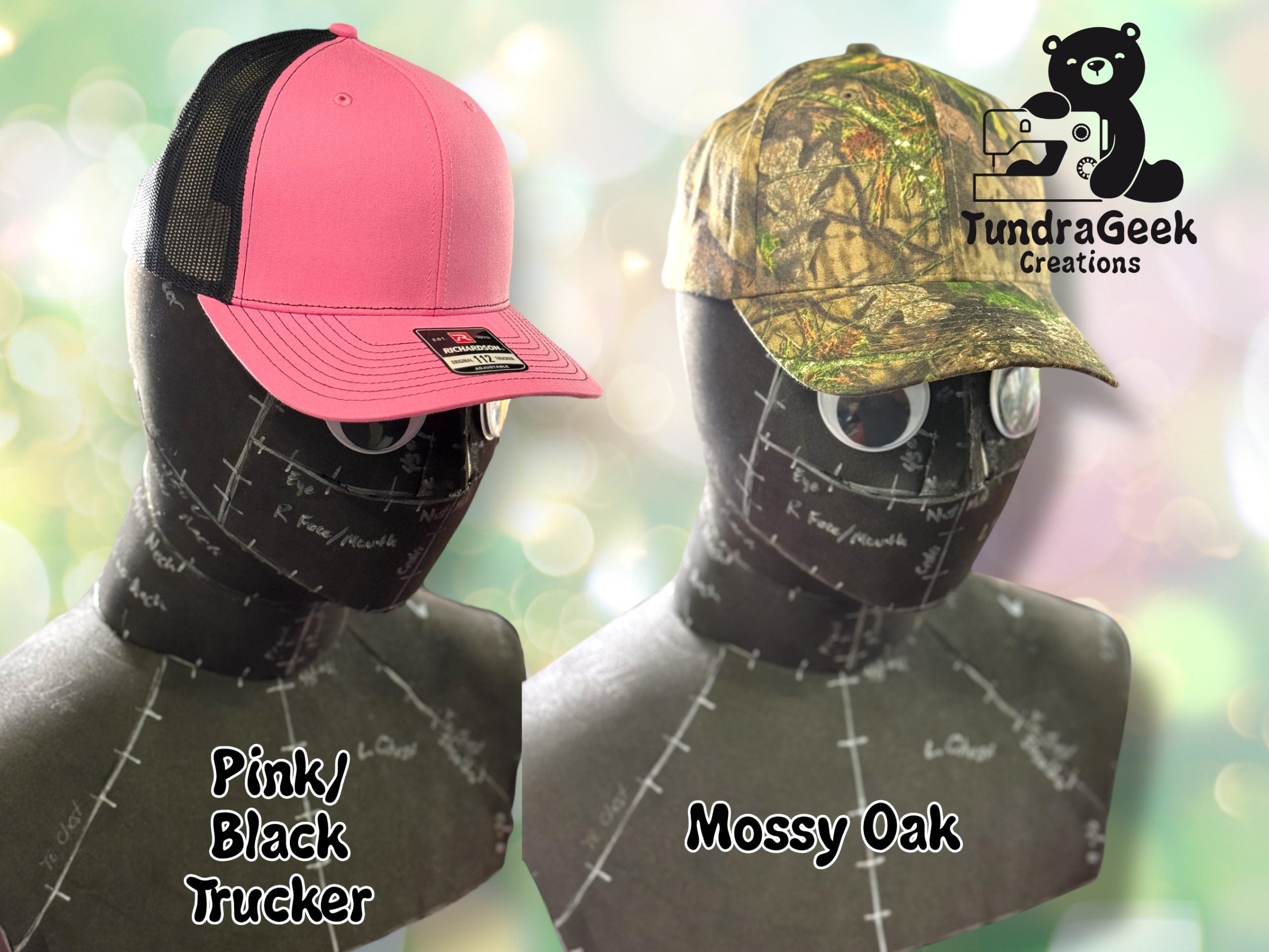 Two mannequin heads display caps: one is a pink and black trucker hat, the other is a camouflage-pattern Mossy Oak cap. TundraGeek Creations logo is in the top right corner.
