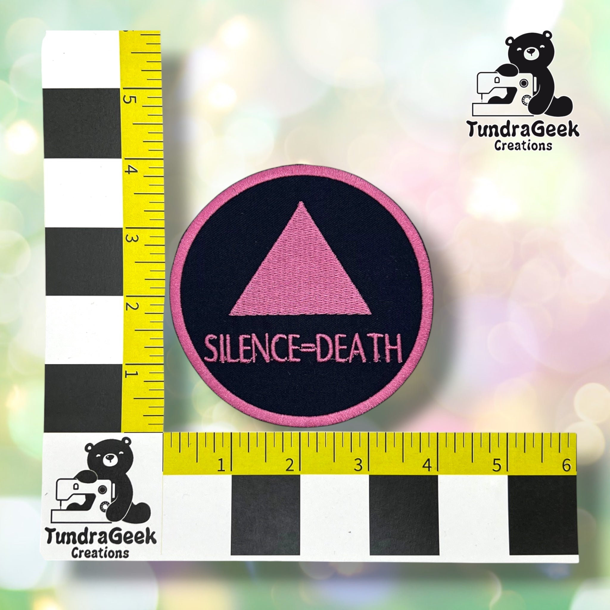 Round variant shown against a black-and-white checkered background with yellow rulers for scale, measuring approximately 4 inches in diameter.  ---