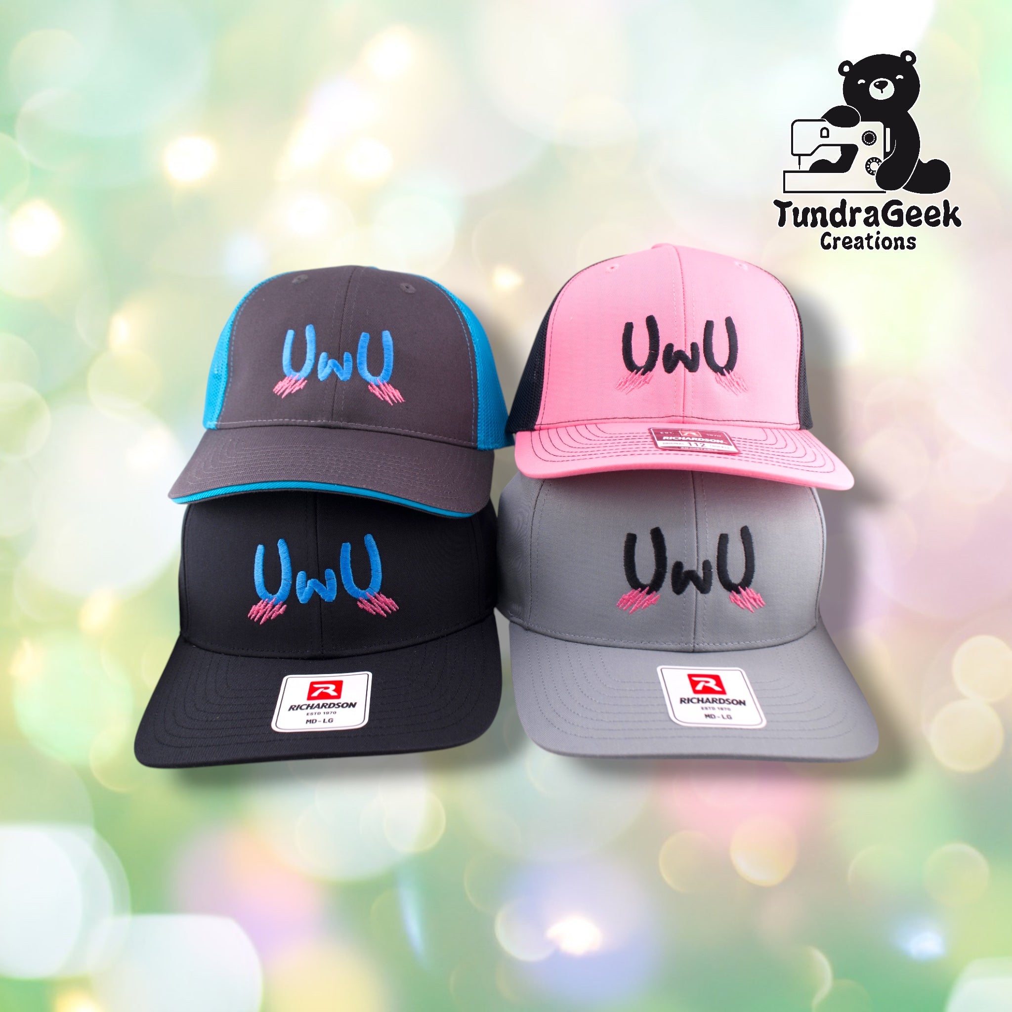 Four Richardson baseball caps in blue, black, pink, and gray displaying embroidered "UwU" faces with closed eyes and pink eyelashes, arranged on a soft-focus pastel backdrop.