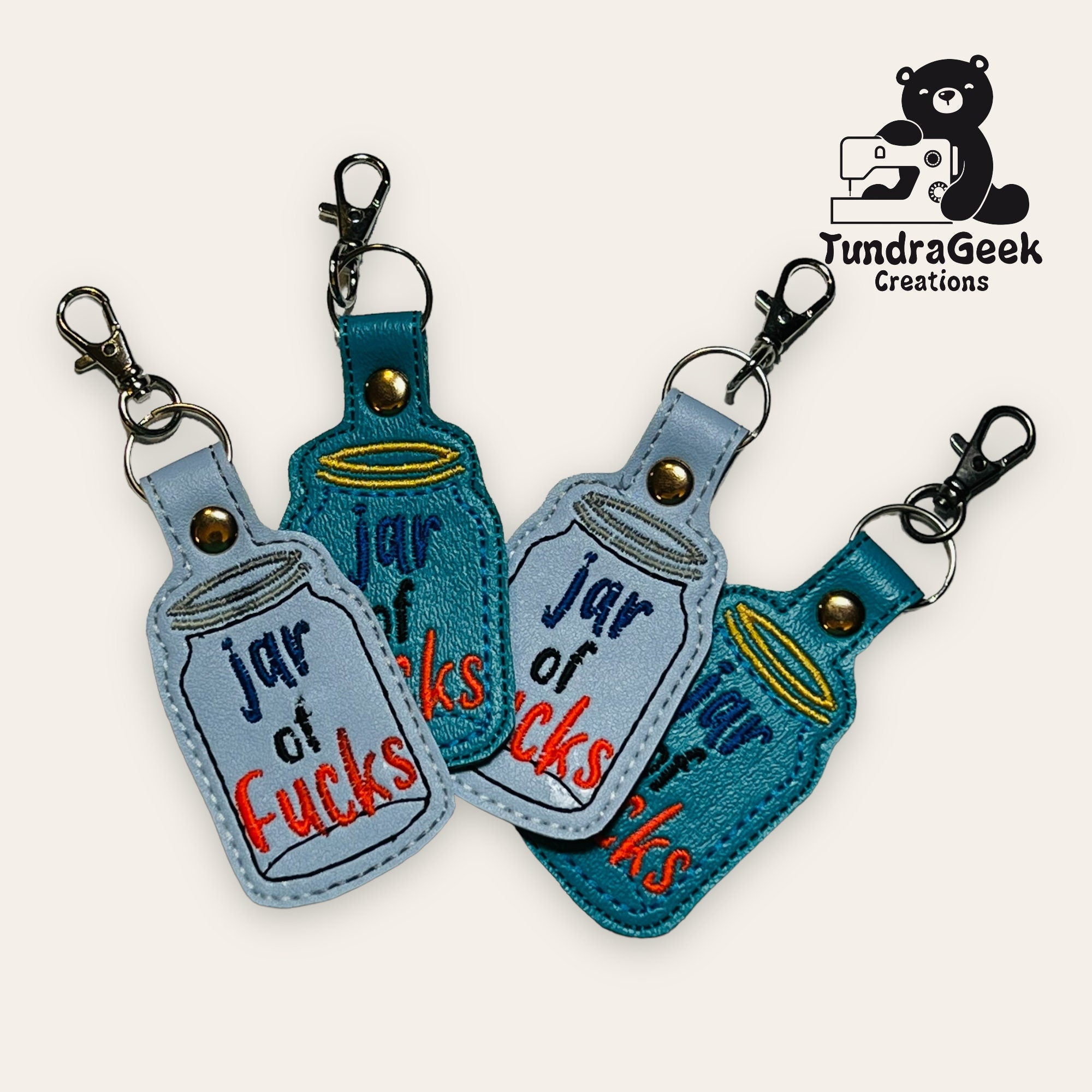 Four embroidered keychains shaped like jars, each labeled jar of fucks, displayed with a TundraGeek Creations logo in the top right corner.