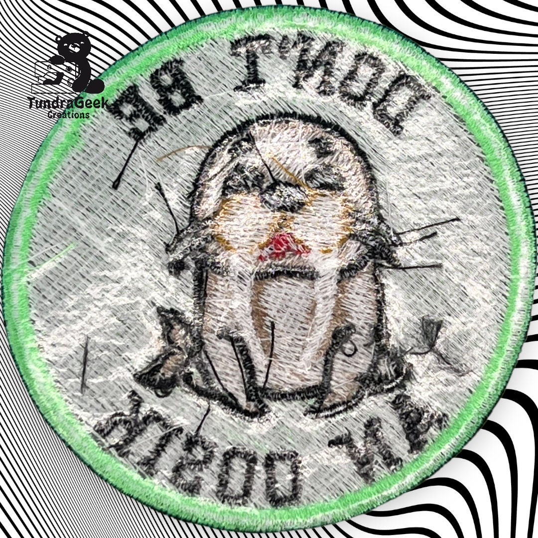 A circular embroidered patch with a distressed otter design, the text DONT BE AN OTTER around the image, and a green border. Background is black and white wavy lines.