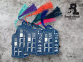 Four blue embroidered keychains shaped like a TARDIS with BAD WOLF text and colorful tassels, set on a gray background with the TundraGeek Creations logo.