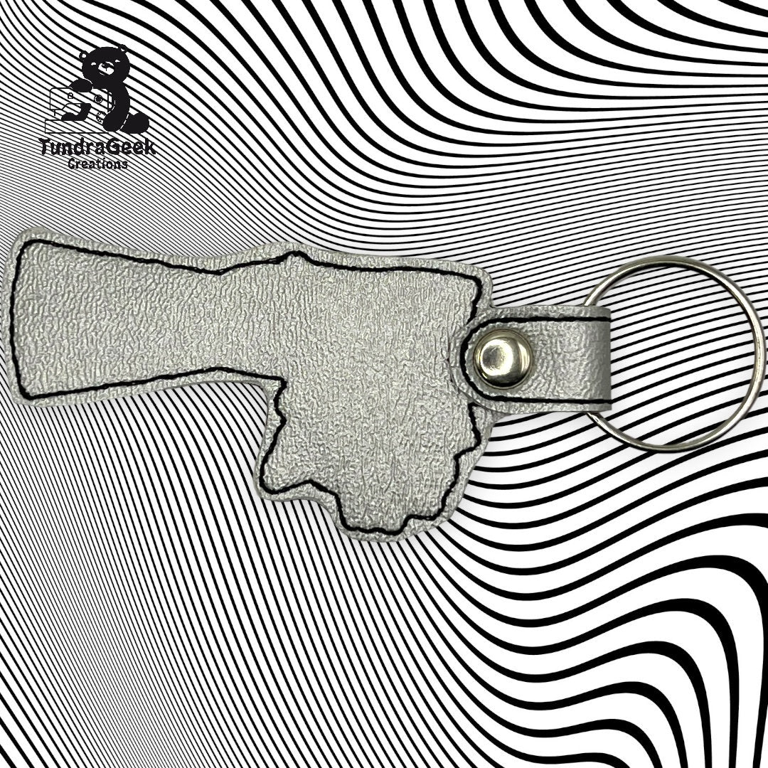A textured leather keychain in the shape of a hand pointing right, placed on a black and white wavy line background.