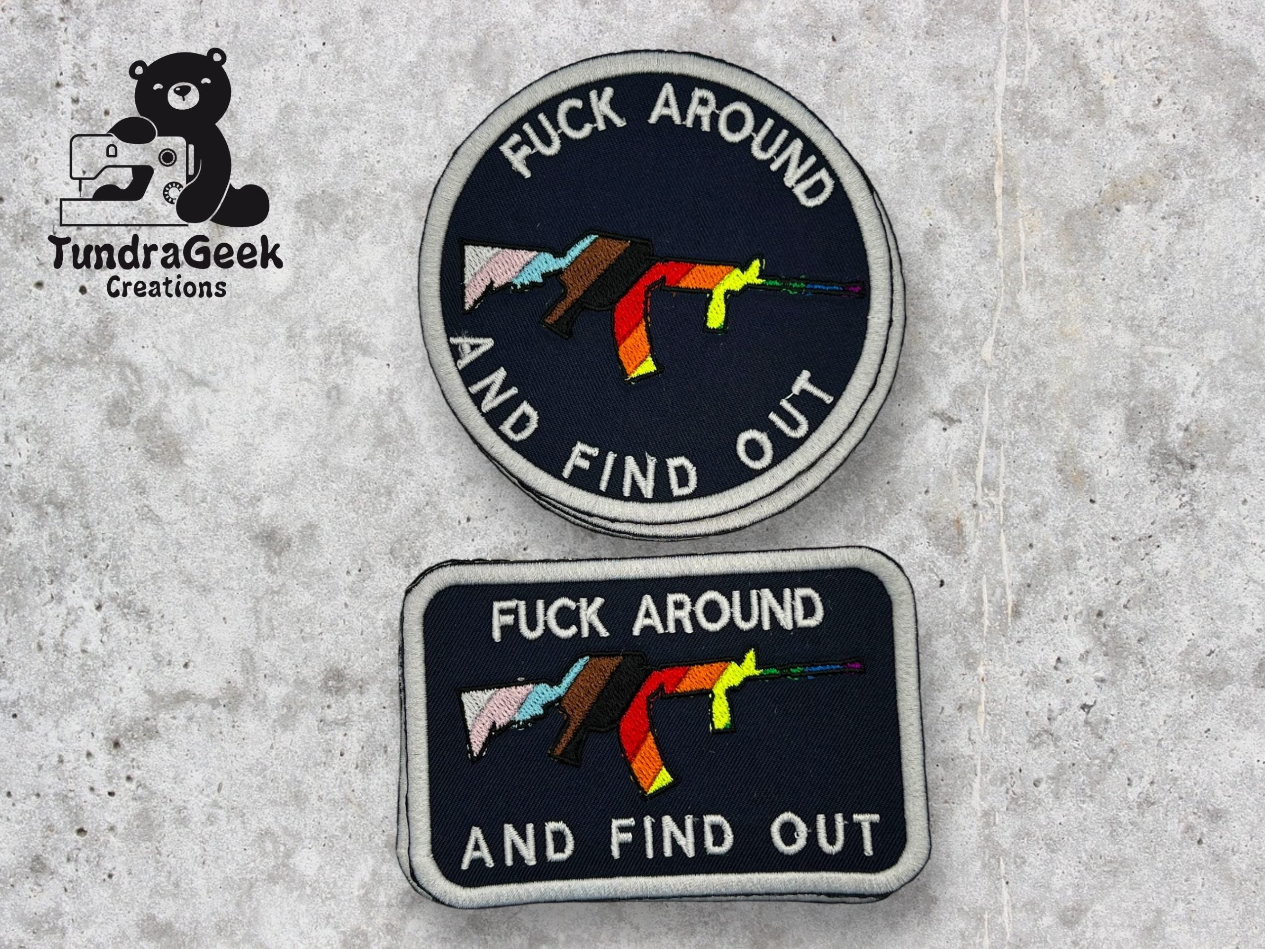Two embroidered patches with a graphic of a rifle and the text FUCK AROUND AND FIND OUT. Logo for TundraGeek Creations with a bear and sewing machine is on the left.