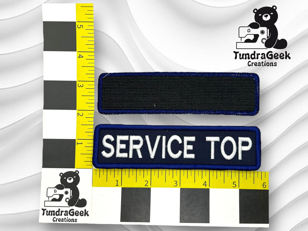 Two rectangular fabric patches, one blank and one labeled SERVICE TOP, are shown on a measuring grid with TundraGeek Creations logos featuring a bear and a sewing machine.