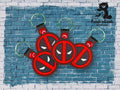 Four red and black keychains with a masked face design are displayed on a blue brick background. The TundraGeek Creations logo is in the top right corner.