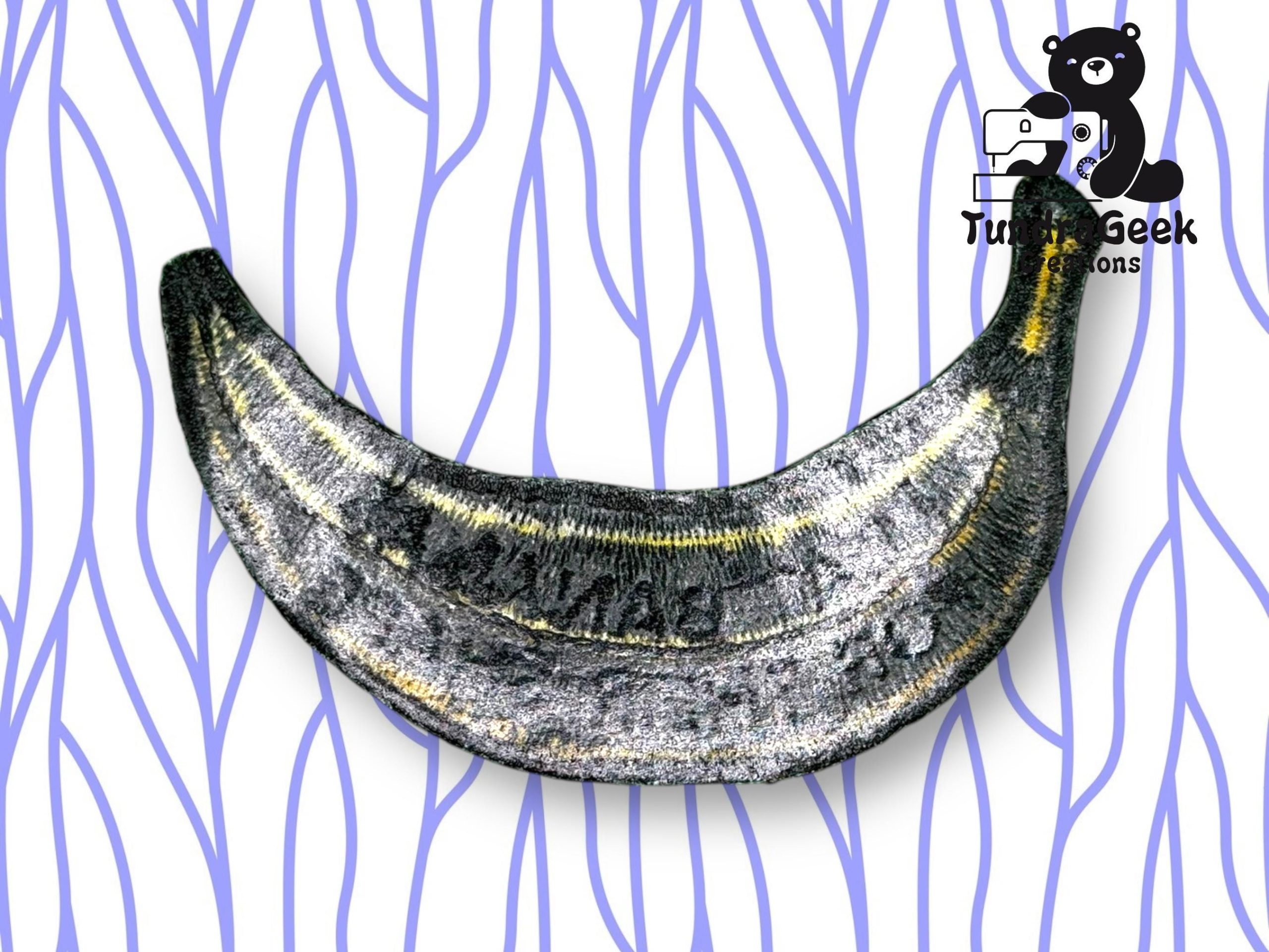 A metallic, crescent-shaped object resembling a banana on a white background with blue wavy lines and a cartoon bear logo in the corner.