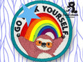 A circular embroidered patch features a smiling sloth with arms raised under a rainbow, with the text “GO F*** YOURSELF” partially obscured by a blue star. TundraGeek Creations logo in corner.