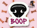 Embroidered patch shaped like a dogs nose with BOOP in purple letters below, surrounded by small dog bone treats on a pink background. TundraGeek Creations logo in top right corner.