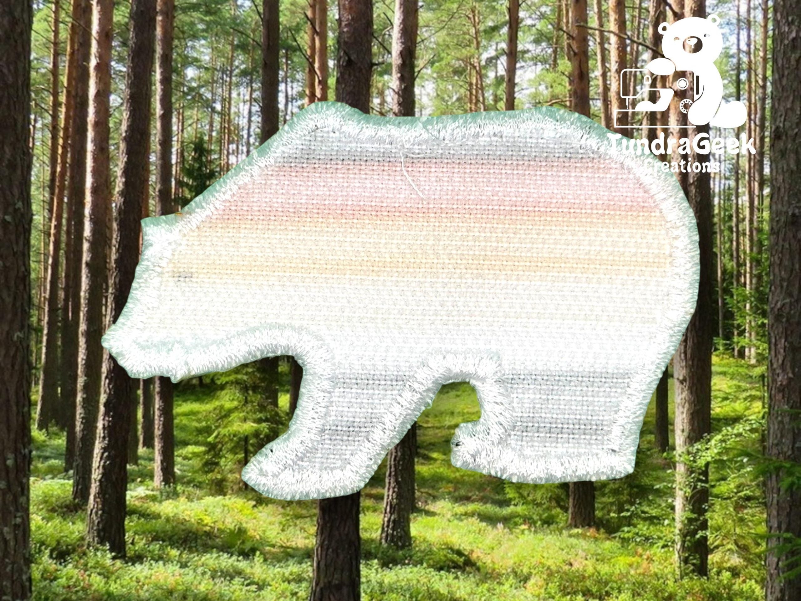 A bear-shaped fabric patch with pastel stripes and a metallic border is superimposed on a forest background. The Tundra Geek Creations logo is in the upper right corner.