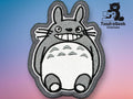 Embroidered patch featuring a cartoon gray creature with large eyes and a wide smile, displayed on a gradient background with TundraGeek Creations logo in the upper right corner.