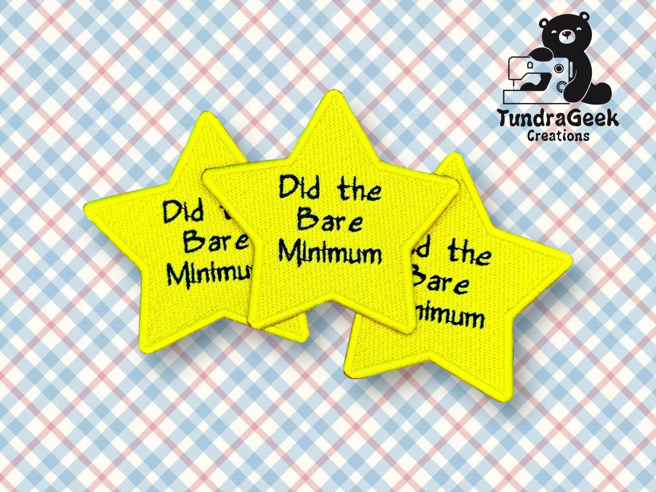Three yellow star-shaped patches read Did the Bare Minimum on a blue and pink checkered background, with a TundraGeek Creations logo featuring a bear in the corner.