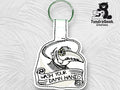 Embroidered keychain featuring a plague doctor illustration and the text Wash Your Damn Hands on a white textured background. TundraGeek Creations logo in the top right corner.