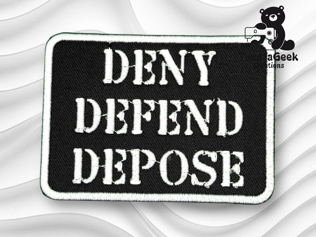 A black rectangular patch with white stitched letters reads DENY DEFEND DEPOSE against a white textured background. A small bear logo with MegaGeek Creations is in the top right corner.