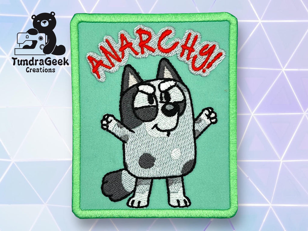 Embroidered patch of a cartoon dog with raised arms, text ANARCHY! in red above, and TundraGeek Creations logo in the corner.