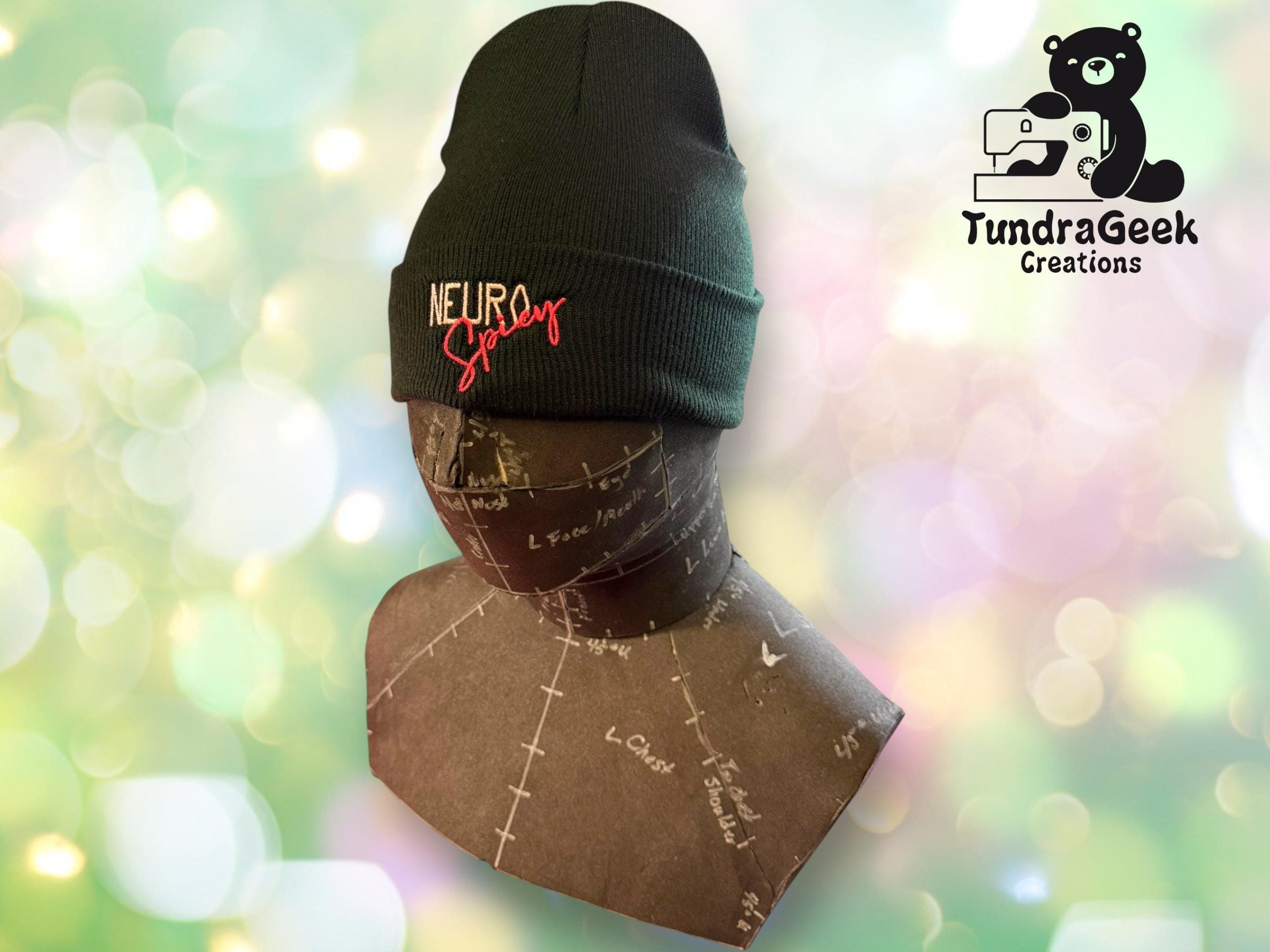 A black beanie with NEURO Spicy embroidered on the front, displayed on a dress form, with the TundraGeek Creations logo in the background.