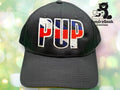 A black baseball cap with PUP embroidered in red, white, and blue letters. The TundraGeek Creations logo with a bear and sewing machine is in the upper right corner.