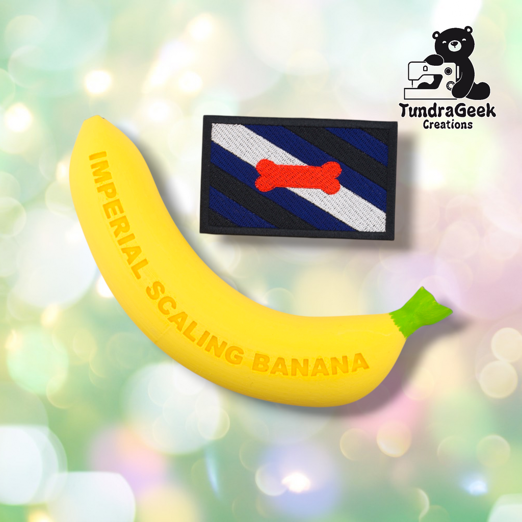 A yellow banana labeled IMPERIAL SCALING BANANA next to the Pup Pride Flag Patch—an embroidered, rectangular patch with blue, black, white stripes and a red bone; TundraGeek Creations logo in the corner.
