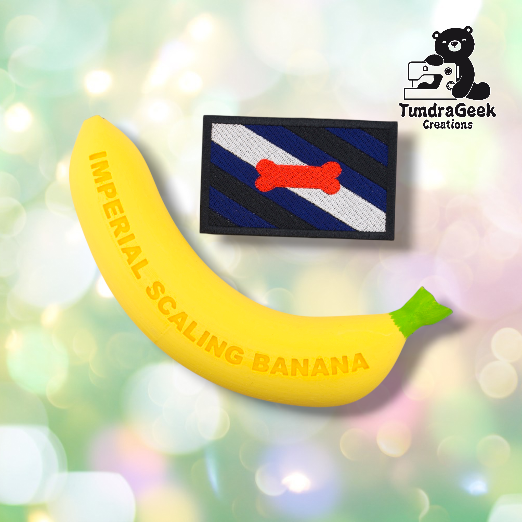 A yellow banana labeled IMPERIAL SCALING BANANA next to the Pup Pride Flag Patch—an embroidered, rectangular patch with blue, black, white stripes and a red bone; TundraGeek Creations logo in the corner.